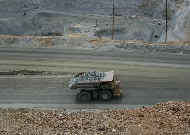 Open-pit mine with mining equipment and a haul truck